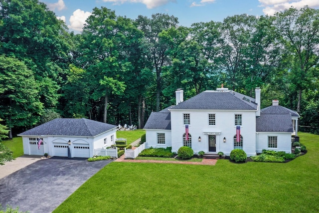 view of front of property featuring a garage and a front yard