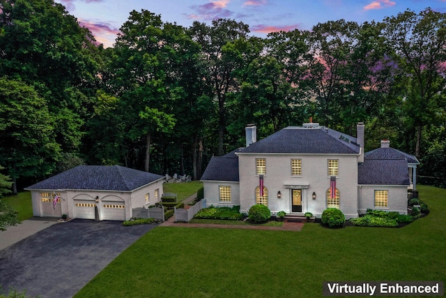 view of front facade with a lawn and a garage