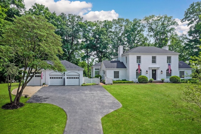 view of front of house with a garage and a front yard