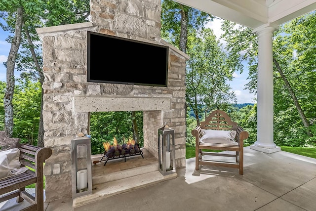 view of patio / terrace featuring an outdoor stone fireplace