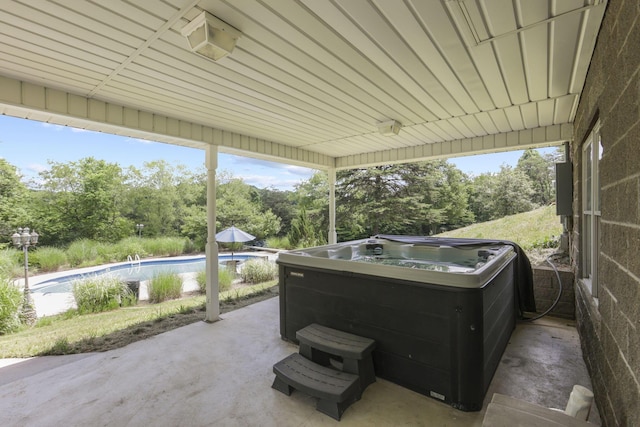 view of patio with a swimming pool with hot tub