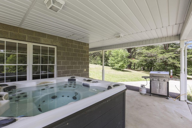 view of patio with a grill and a hot tub