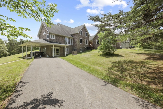 view of front of house with cooling unit and a front yard