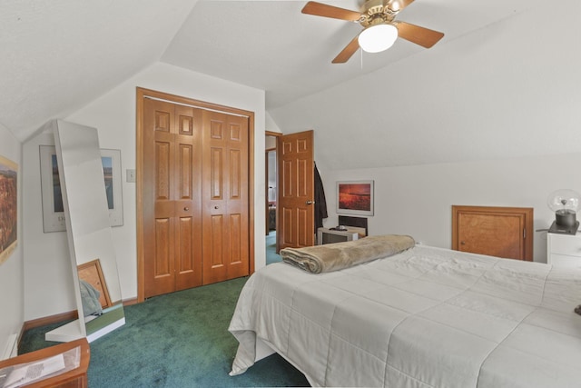 bedroom featuring ceiling fan, dark carpet, lofted ceiling, and a closet