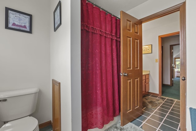 bathroom with tile patterned floors and toilet