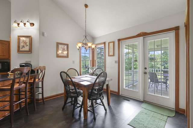 dining space featuring high vaulted ceiling and a notable chandelier