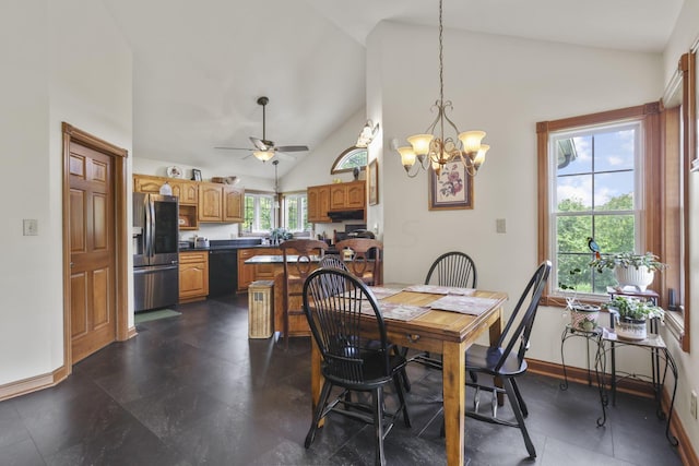 dining space with high vaulted ceiling and ceiling fan with notable chandelier