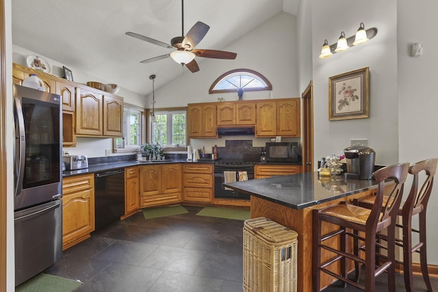 kitchen featuring a breakfast bar, ceiling fan, sink, black appliances, and high vaulted ceiling