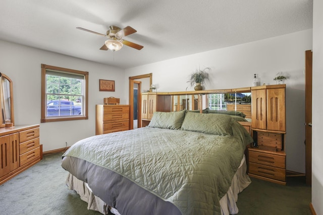 carpeted bedroom with a textured ceiling and ceiling fan