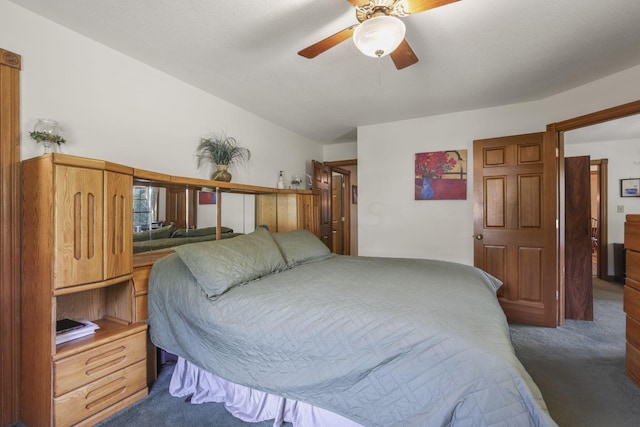 carpeted bedroom featuring ceiling fan and lofted ceiling