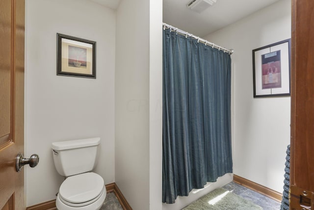 bathroom with a shower with curtain and toilet