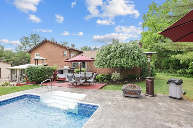 view of pool with a patio area and an outdoor fire pit