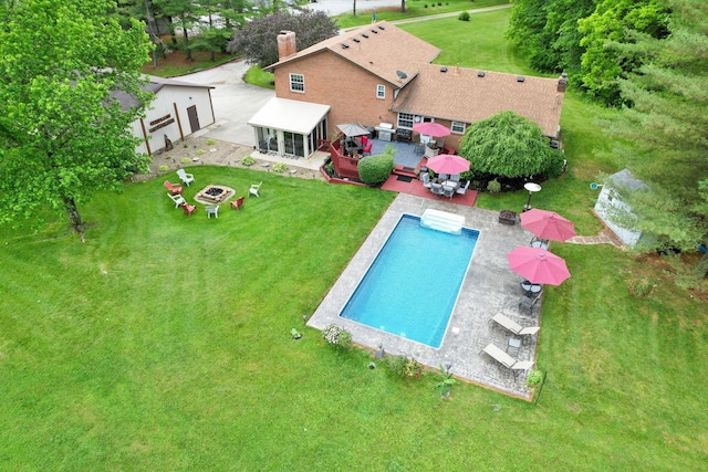 view of pool with a patio and a fire pit