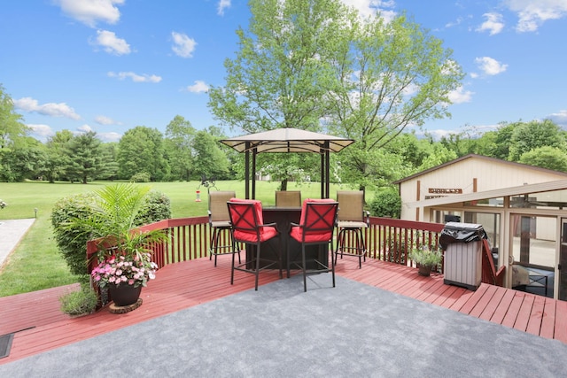 deck with grilling area, a lawn, and a sunroom