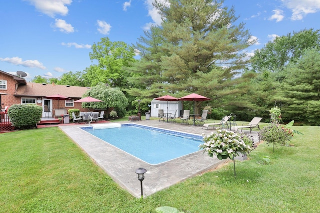 view of pool with a yard and a deck