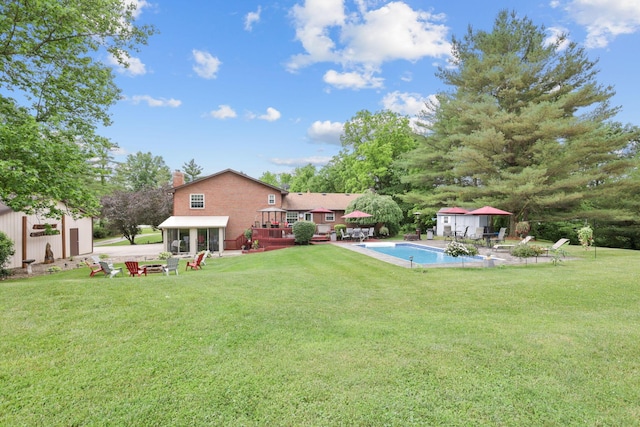 view of yard with a swimming pool side deck and a storage shed