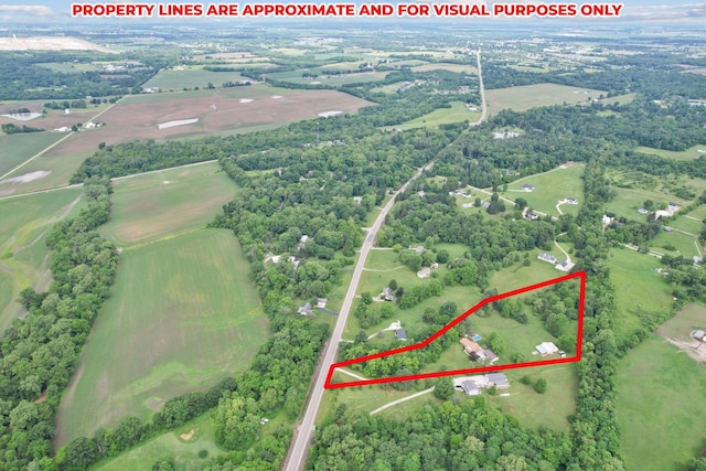 birds eye view of property with a rural view