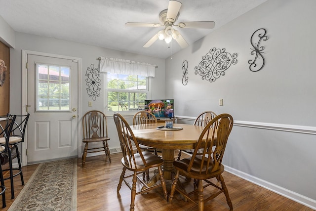 dining area with hardwood / wood-style flooring and ceiling fan