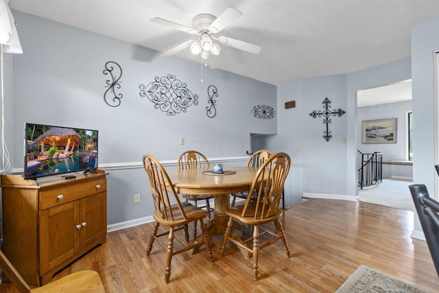 dining space with ceiling fan and light hardwood / wood-style floors