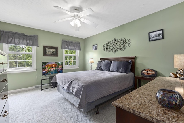 bedroom with ceiling fan and light colored carpet