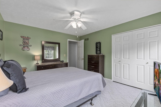 bedroom with ceiling fan and a closet