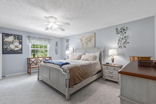 carpeted bedroom with a textured ceiling and ceiling fan