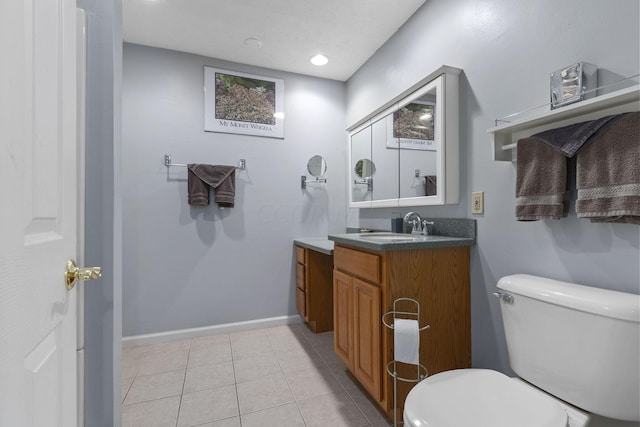 bathroom featuring tile patterned flooring, vanity, and toilet