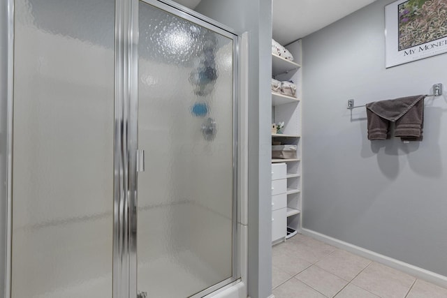 bathroom featuring tile patterned flooring and a shower with door