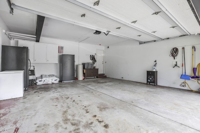 garage with refrigerator and a garage door opener