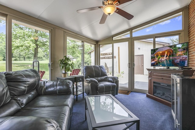 sunroom featuring ceiling fan and lofted ceiling