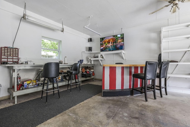 bar with a workshop area and ceiling fan