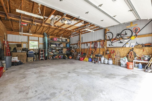 garage with a workshop area and a garage door opener