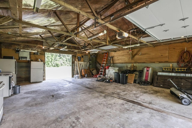 garage with electric panel, a garage door opener, and white refrigerator