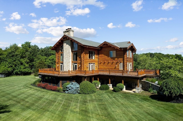 back of property featuring a lawn and a wooden deck