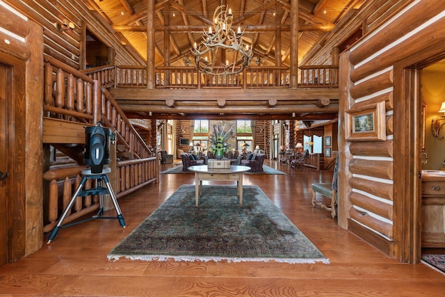 foyer with a chandelier, wood-type flooring, high vaulted ceiling, and wooden ceiling