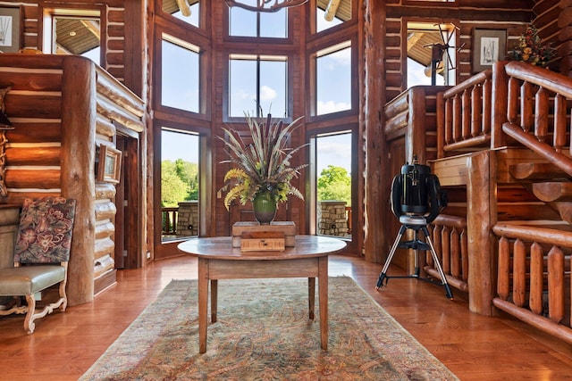 interior space featuring hardwood / wood-style flooring, a healthy amount of sunlight, and a high ceiling