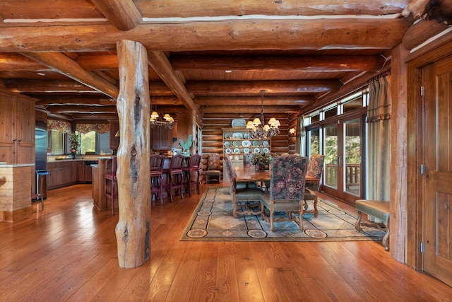 unfurnished dining area with light wood-type flooring, rustic walls, and a wealth of natural light