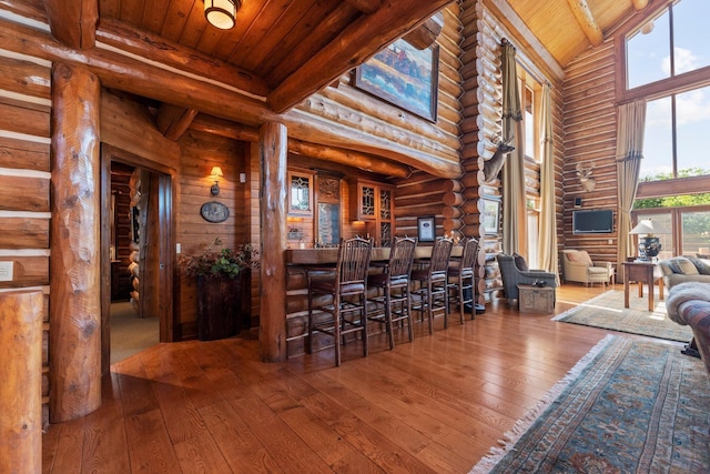 interior space featuring wood-type flooring, a healthy amount of sunlight, and wood ceiling