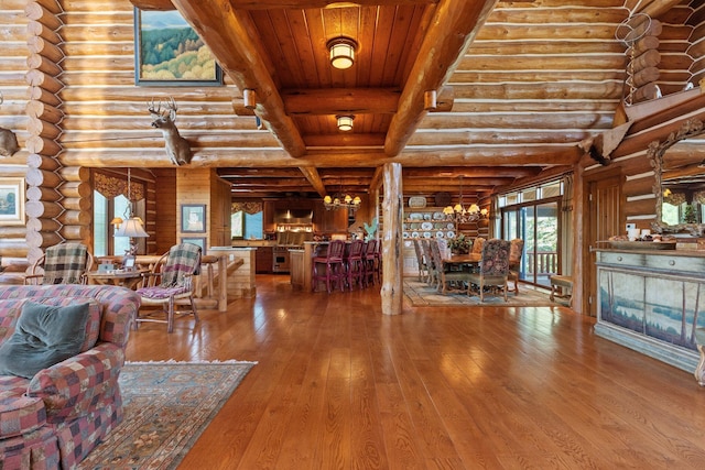 unfurnished living room with hardwood / wood-style floors, rustic walls, beam ceiling, wood ceiling, and a chandelier