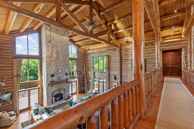 corridor featuring plenty of natural light, wood ceiling, high vaulted ceiling, and light hardwood / wood-style flooring