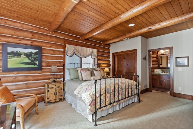 bedroom featuring beam ceiling, wood ceiling, rustic walls, and ensuite bath