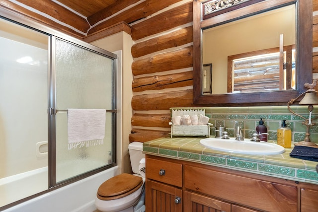 full bathroom featuring decorative backsplash, vanity, bath / shower combo with glass door, and toilet