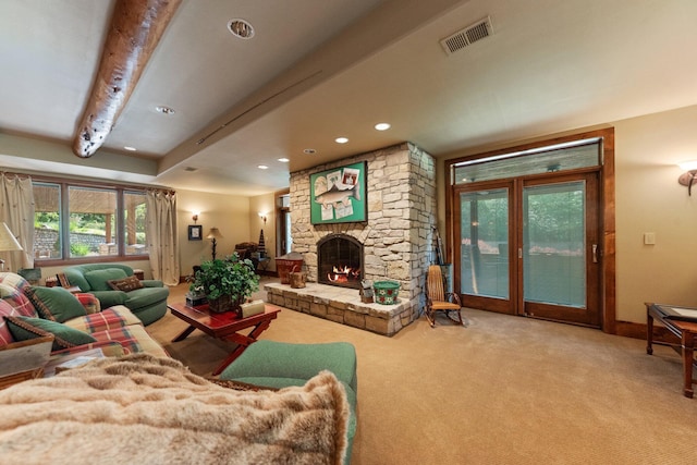 carpeted living room featuring a fireplace and beam ceiling