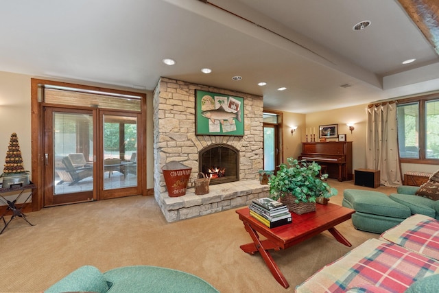 living room with carpet, plenty of natural light, and a fireplace