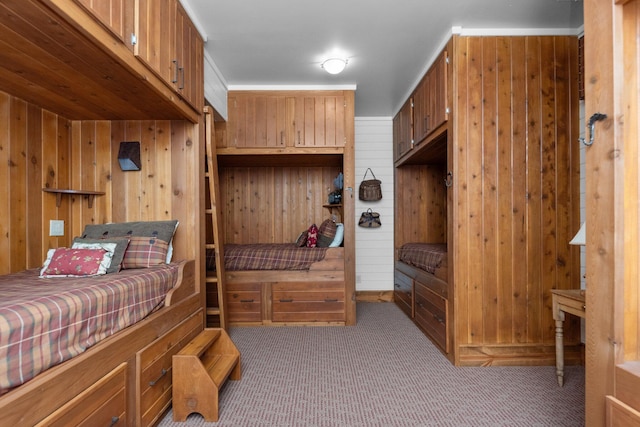 bedroom with light carpet and wooden walls