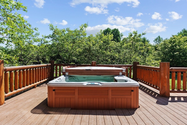 wooden deck with a hot tub