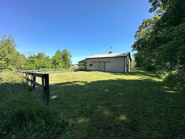 view of yard with an outbuilding and a rural view