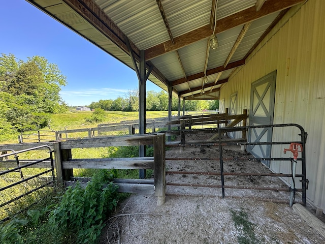 view of stable with a rural view