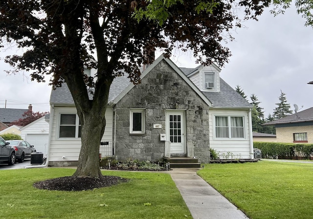 view of front of home with cooling unit and a front lawn