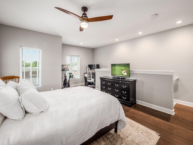 bedroom with ceiling fan and dark hardwood / wood-style flooring